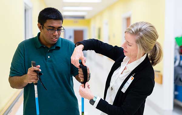 Multiple sclerosis occupational therapist helps a patient in the MS clinic