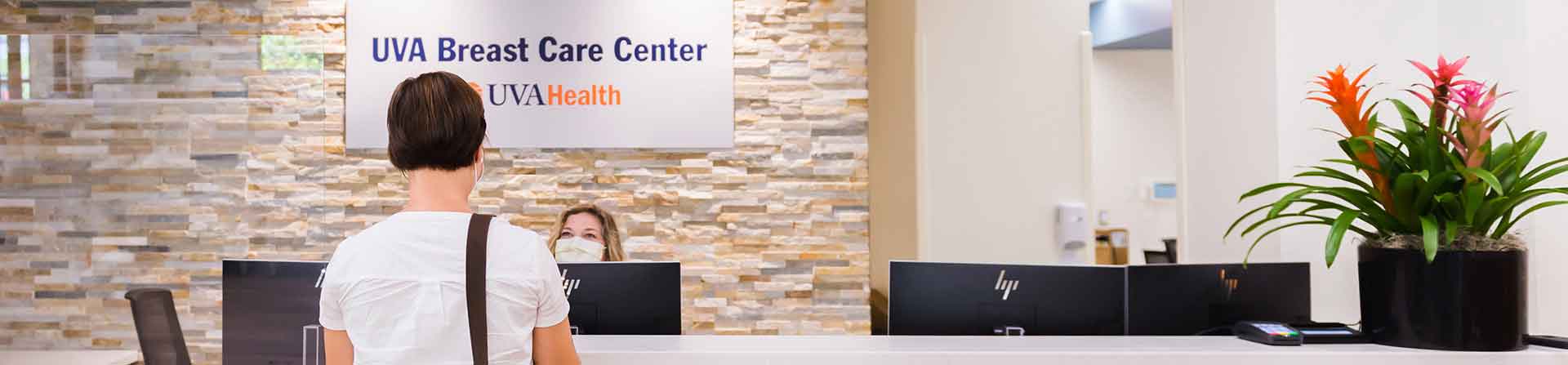 patient checks in for breast cancer care at the welcome desk