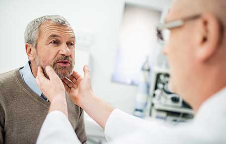 Older patient gets evaluated as part of speech training after larynx removal.