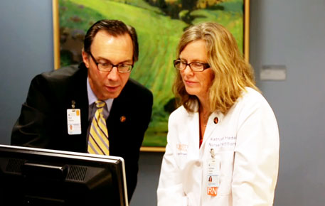 two digestive specialists review research on a computer screen