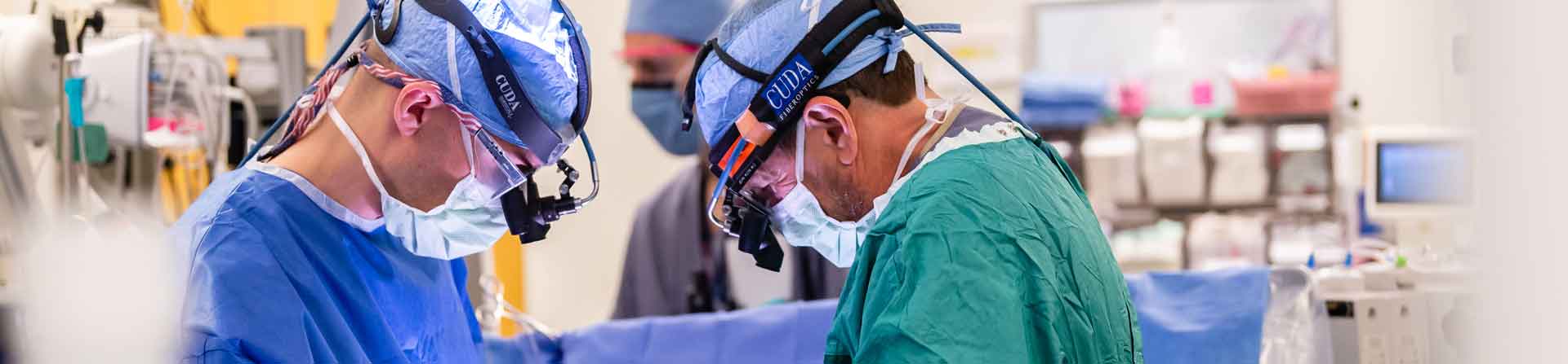 Two surgeons working together on a heart transplant