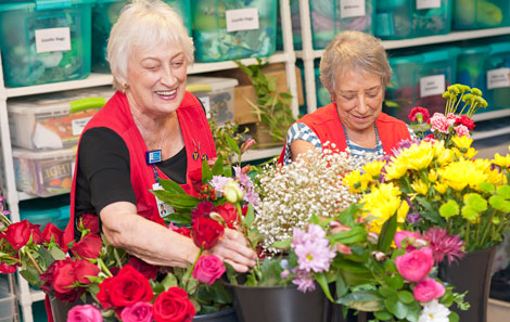 volunteers creating flower arrangements for patients
