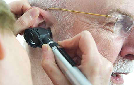 Man getting his hearing checked by an audiology specialist