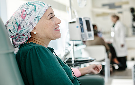 A woman smiling while getting infusion at the UVA infusion center