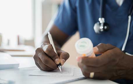 A UVA Health doctor writes a prescription at a local clinic