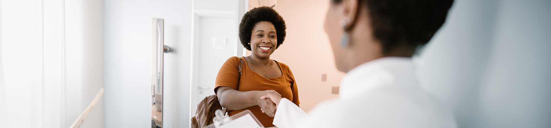 Relieved patient shakes hands with provider